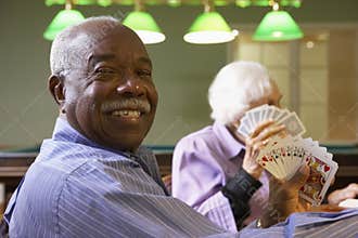 Senior adults playing bridge