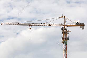 Construction site view of crane, lift, metal beam, brick, metal ladder and concrete