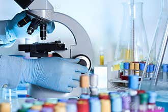 Researcher at the microscope lab workbench