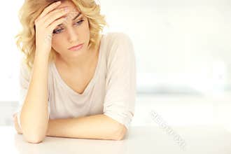 Young depressed woman at home