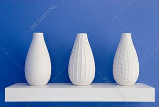 White vases on blue