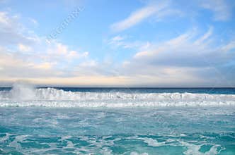 White foamy waves and gradually darkening color of sea