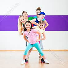 Kids train Zumba fitness in dancing school