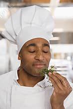 Chef savouring aroma of herbs