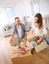 Young adults unpacking boxes