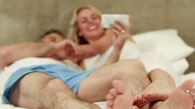 Happy couple using smartphone