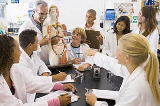 School children and their teacher in science class
