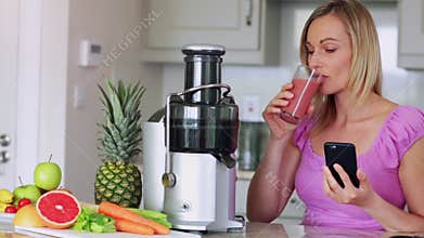 Blonde drinking fresh fruit and vegetable juice