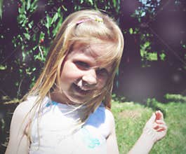 Portrait of a little blonde smiling girl; soft retro style