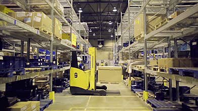 Forklift operator loading container on rack