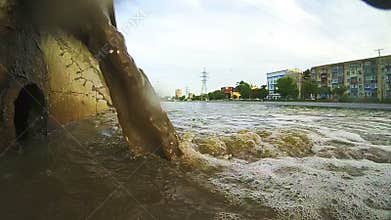 Waste water to city canal. Industrial pipe discharging liquid waste.