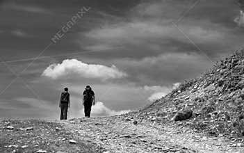 Active young couple on mountain path. Pleasant hike on the mountain. Mountain landscape