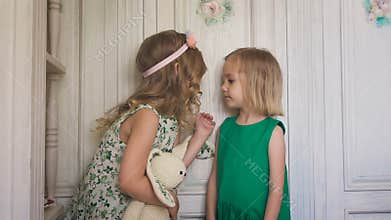 Two playful cute girls kissing each other