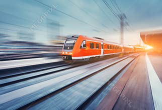 Modern high speed red passenger commuter train. Railway station