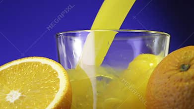 Pouring a glass of orange juice creating splash