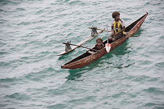 Mother and child in canoe on Pacific Ocean