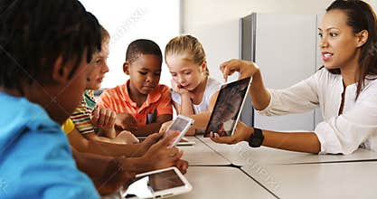 Teacher teaching kid on digital tablet in library