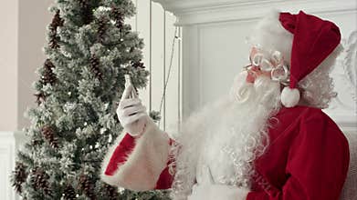 Laughing Santa Claus reading Christmas messages from kids