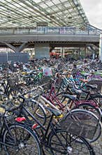 Environmentally friendly transportation: Parked bikes in front of train station, Copenhagen, Denmark