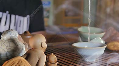 Traditional Chinese Tea Ceremony and pour the tea in a glass of the clay. Pouring Tea With The Help Of Ladle