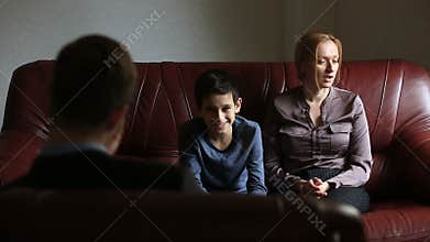 Consultation of a psychologist. Male psychologist consults with a woman and her teen son, family counseling