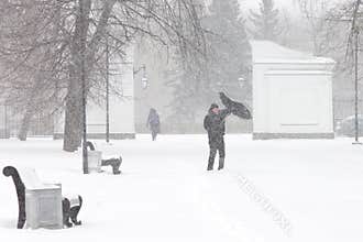 Bad weather in a city: a heavy snowfall and blizzard in winter
