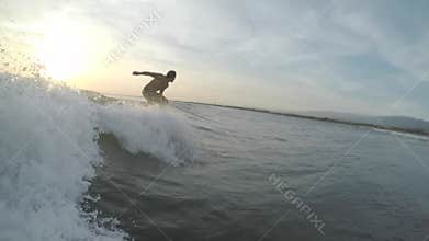 Amateur surfer rides the wave