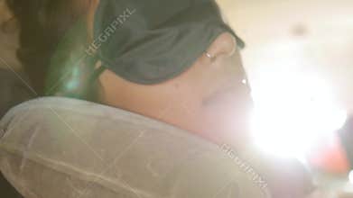 Sleeping Asian Woman Wearing Blindfold Sleeping Mask in Airplane. Young Traveller Girl in the Morning in Plane. HD