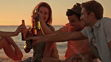 Friends drinking beer at the beach