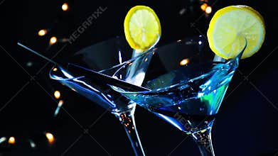 Barman pouring blue cocktail drink on a disco bar table, disco atmosphere