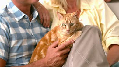 In slow motion happy couple with cat