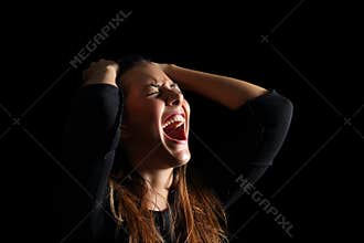 Depressed woman crying and shouting desperate in black