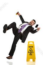 Senior Businessman Falling on Wet Floor