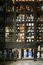 A collection of ceramics is exposed in a display cabinet in a museum in Hoi An (Vietnam)