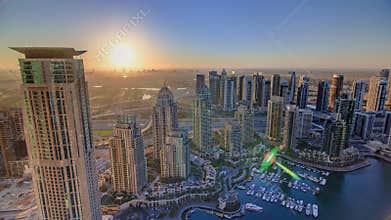 Sunrise in Dubai Marina with towers and harbor