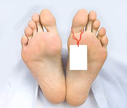 Two feet of a dead body, with blank sign