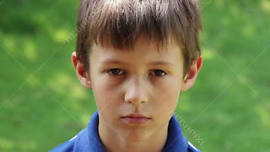Portrait Of Sad Young Caucasian Boy Looking At Camera