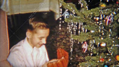 1954: Happy boy gets baseball glove for Christmas gift. NEWARK, NEW JERSEY