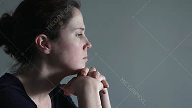Caucasian woman in her thirties (30s) sitting at a table upset