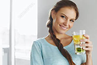 Healthy Lifestyle And Food. Woman Drinking Fruit Water. Detox. H