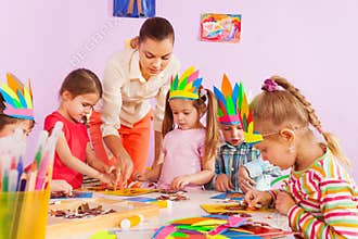 Teacher teach preschool kids in art class
