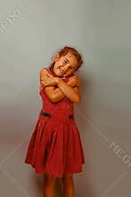 Girl European appearance decade hugging herself on
