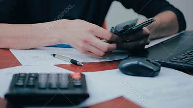 A man with calculator and bills counting money. Finances, business, economy.