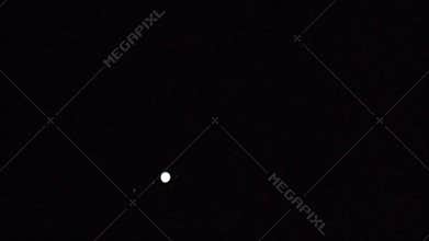 Jupiter and its moons, moving. Long lens.