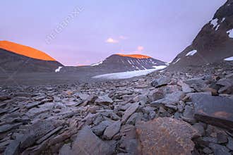 Tranquil vibrant sunset with insane red coloration of the glacier valley mountains