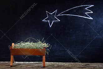 Birth of Jesus with manger and star on blackboard