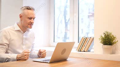 Angry Middle Age Man Working on Laptop
