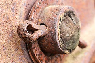 Close up of rusted cotter pin on abandoned farm equipment