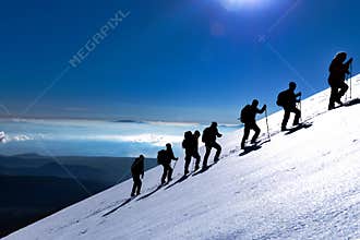 Walk of climbers on top of mountains at sunrise time