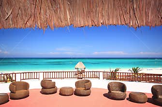 Beach resort with a thatched roof overlooking trop